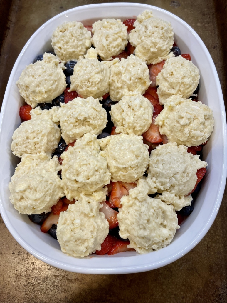 Cover the fruit with biscuit topping